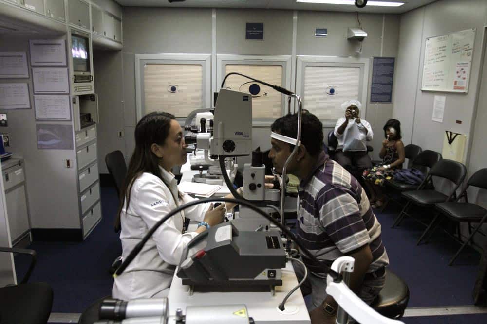An Orbis eye care professional, left, examines eyes of an Indian patient inside the Orbis flying eye hospital in Kolkata.