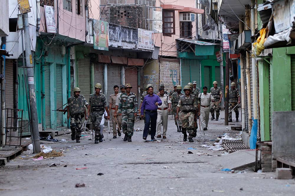 Officials and security forces patrol during an army-enforced curfew imposed following deadly clashes between Hindus and Muslims at Muzaffarnagar in Uttar Pradesh state.