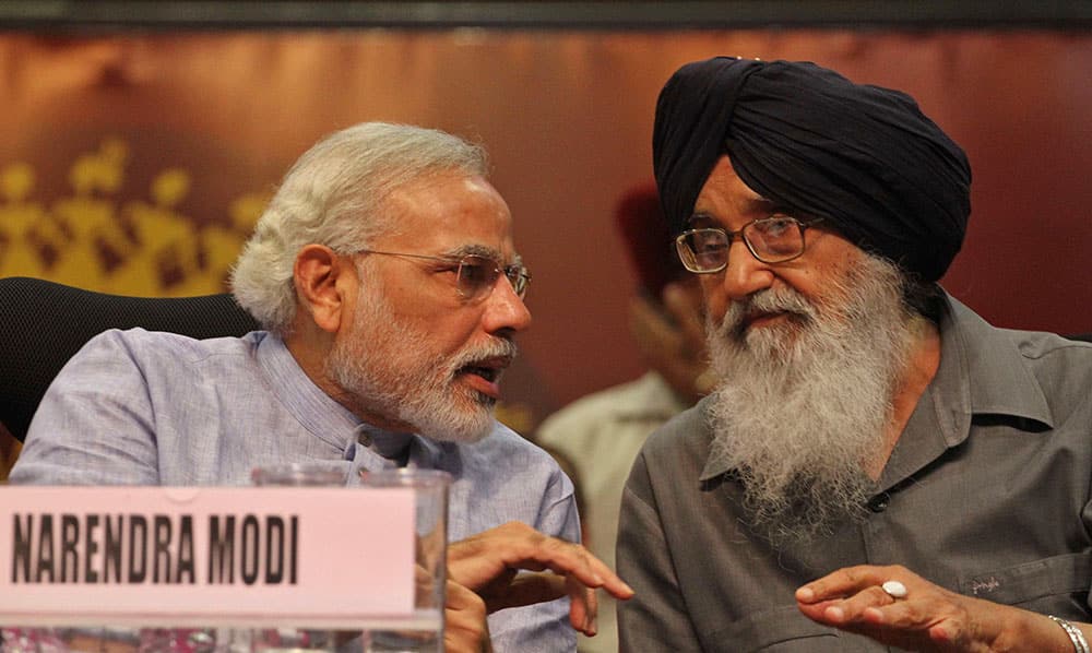 Gujarat Chief Minister Narendra Modi, talks to his Punjab state counterpart Prakash Singh Badal during the inauguration of Vibrant Gujarat Agriculture Summit, a two day meeting of thousands of farmers in Gandhinagar.