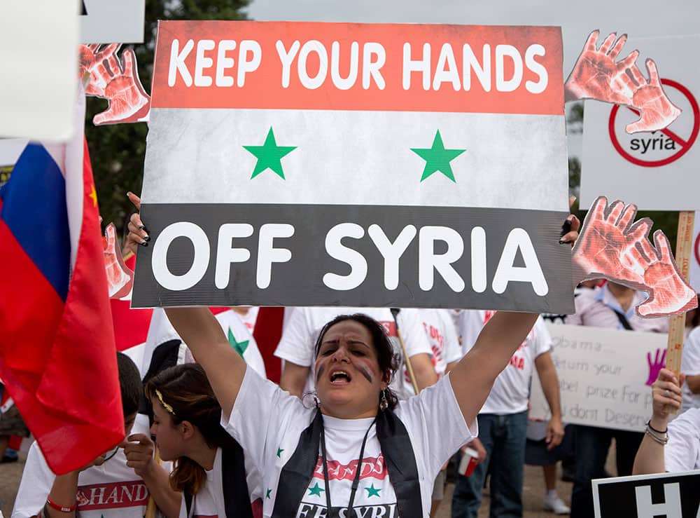 Protesters against US military action in Syria shout during a demonstration in front of the White House in Washington.