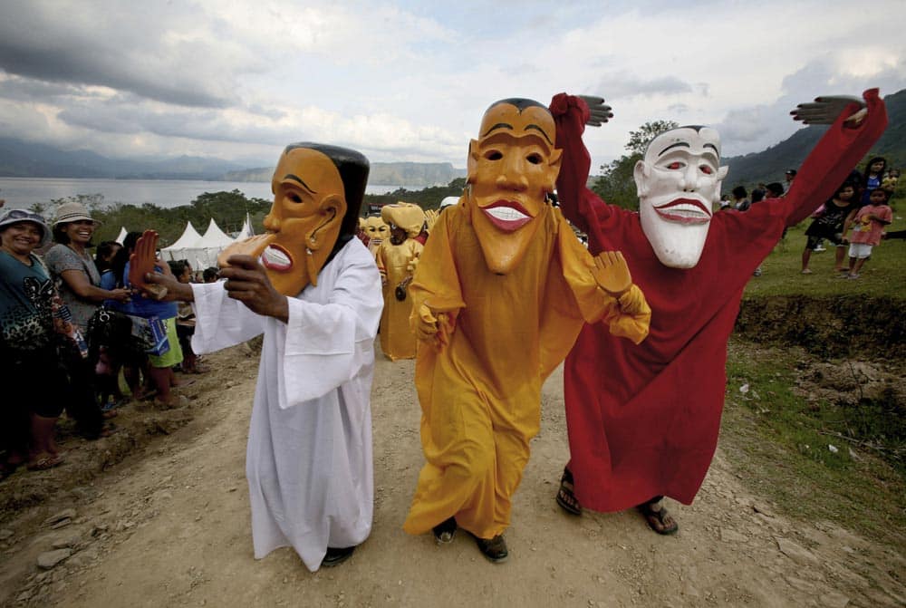 Artists perform a traditional mask dance called Gundala Gundala, during Lake Toba Festival on Samosir island, North Sumatra, Indonesia.