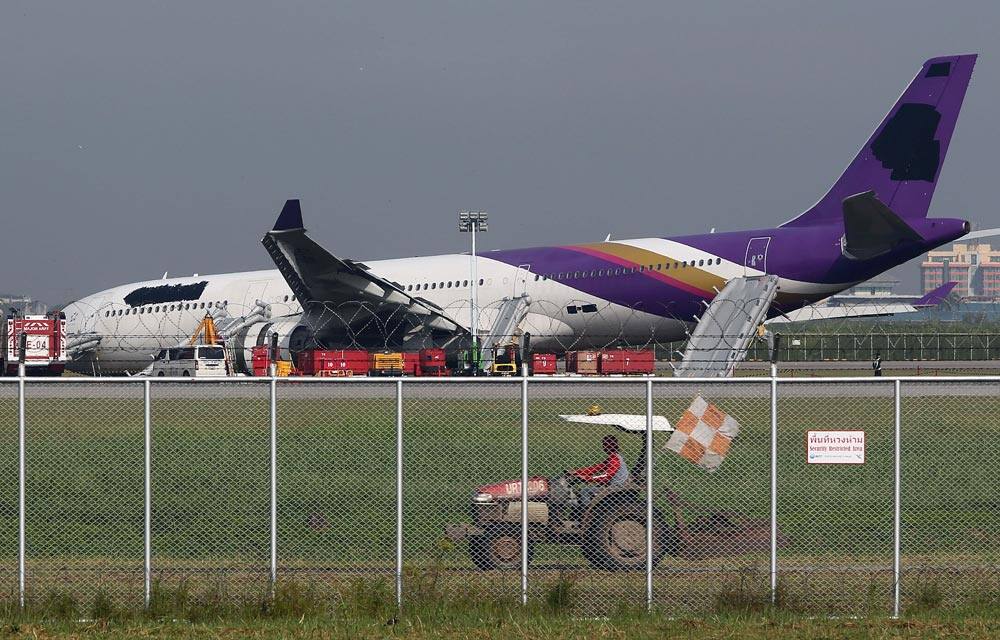 An airport worker drives a cart past a damaged Thai Airways Airbus A330-300 at Suvarnabhumi International Airport in Bangkok.