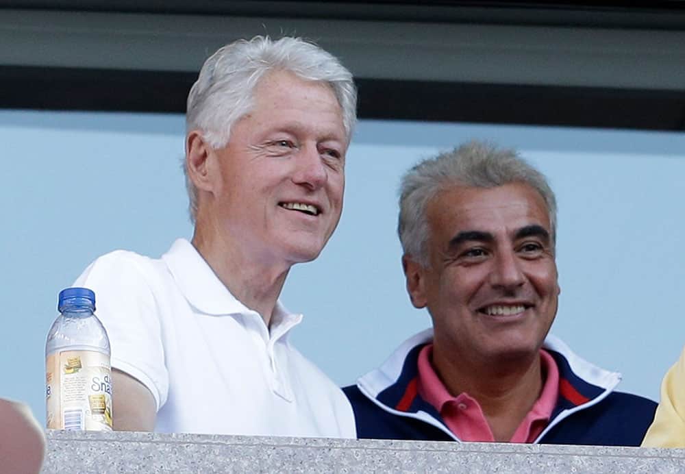 Former president Bill Clinton, left, watches play between Victoria Azarenka, of Belarus, and Serena Williams during the women`s singles final of the 2013 US Open tennis tournament.