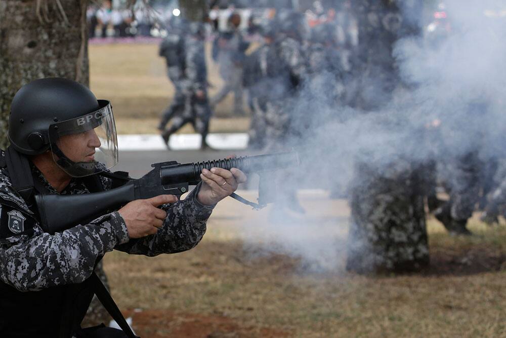 Military police fire tear gas at protesters after the military ceremony marking Independence Day in Brasilia, Brazil. Brazilians are protesting corruption and poor public services.