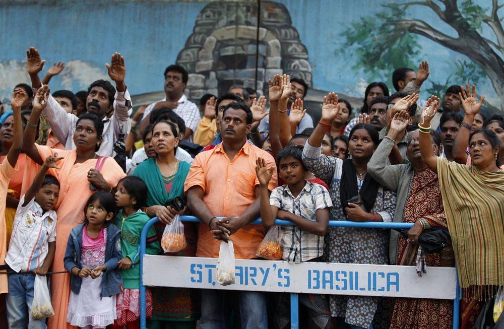 Worshippers react to a priest as they participate in Mary`s Feast outside the St. Mary`s Basilica, the oldest church of Bangalore.