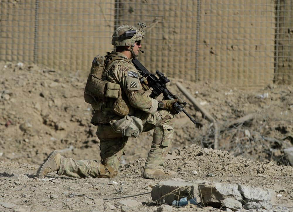 An American soldier, part of the NATO-led International Security Assistance Force (ISAF), kneels down at the site of a suicide attack in Wardak Province, east of Kabul, Afghanistan.