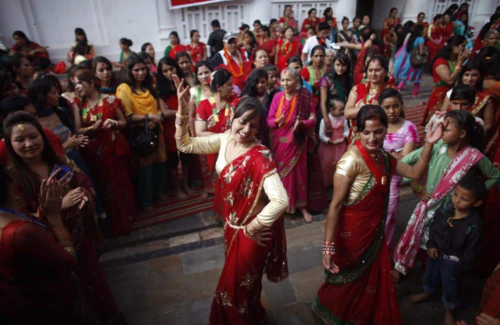 Nepalese Hindu women dance at the Pashupatinath temple during Teej festival celebrations in Katmandu. During this festival, married Hindu women observe day-long fast and pray for their husbands and a happy married life while those unmarried pray for a good husband.