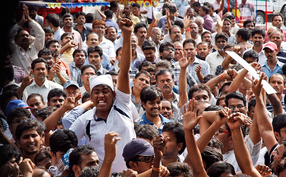 Andhra Pradesh government employee opponents of the creation of a separate state of Telangana carved out from the existing Andhra Pradesh state raise slogans during a meeting in Hyderabad, India.
