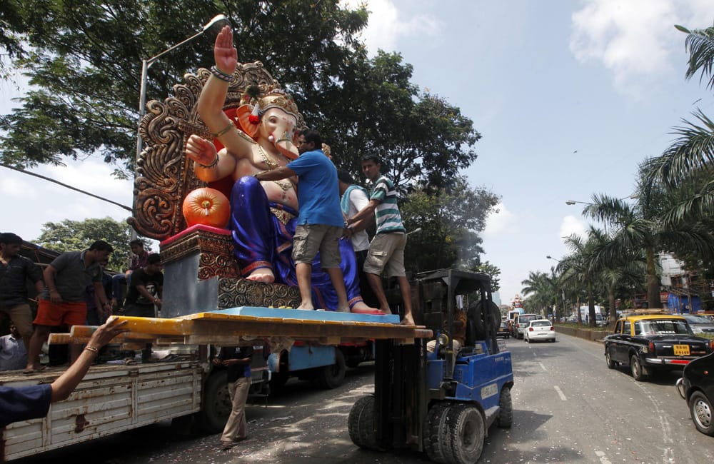 An idol of Hindu God Ganesha is transported towards a worship area ahead of the Ganesh Chaturthi festival in Mumbai.