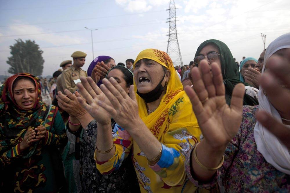 Kashmiri Muslim women sing religious songs as their relatives leave for the annual Hajj pilgrimage to the holy city of Mecca, in Srinagar.