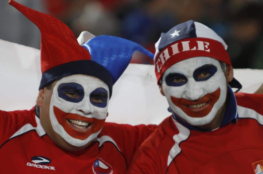 Chile soccer fans wearing face paint pose for a photo before the start of a 2014 World Cup qualifying soccer match against Venezuela in Santiago, Chile.