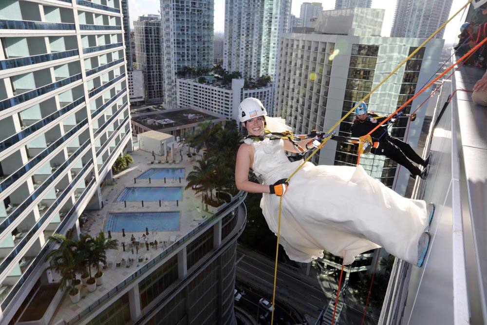 Rebecca Shackelford, left, and Carlos Gato, dressed as a bride and groom take the plunge and go