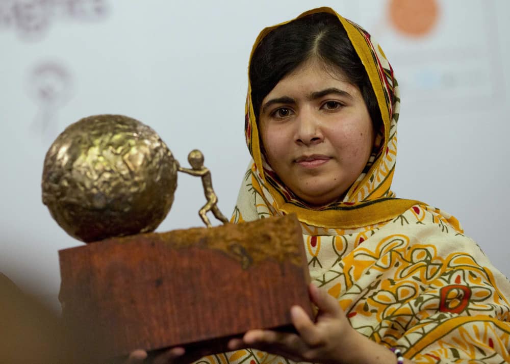 Pakistani teenager Malala Yousafzai, who was shot and injured by the Taliban for advocating girls` education, poses for photographers after being awarded the International Children`s Peace Prize 2013 during a ceremony in the Hall of Knights in The Hague, Netherlands.
