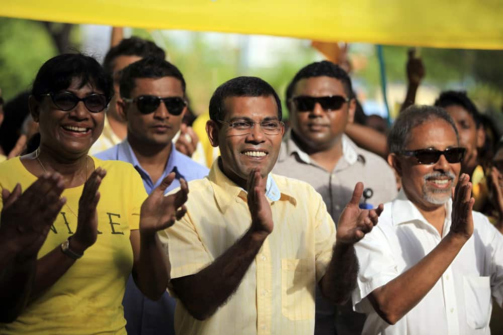 Former Maldivian President Mohamed Nasheed applauds in a final campaign rally ahead of general elections in Male, Maldives.