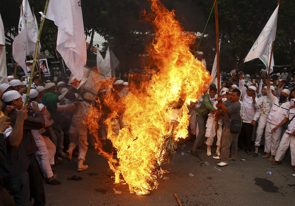 Muslim men burn an effigy of Hary Tanoesoedibjo, head of MNC media group, the local organizer of Miss World 2013, during a protest demanding the cancellation of the pageant that will be held in Bali and Sentul, West Java later this month, in Jakarta, Indonesia.