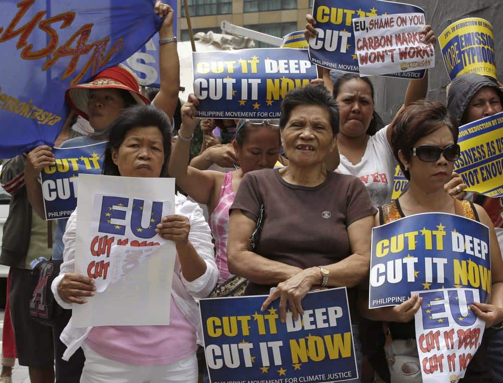 Protesters picket a posh hotel at the financial district of Makati city, east of Manila, to coincide with the visit of EU Commissioner for Climate Action Connie Hedegaard in the Philippines and to demand to increase EU targets to reduce Greenhouse gas emissions.