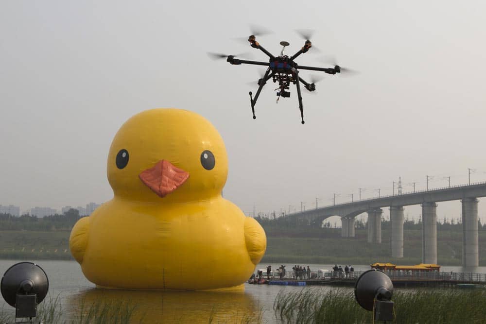 A drone camera hovers near a giant yellow rubber duck created by Dutch artist Florentijn Hofman as an art piece floating in an enclosed branch of Beijing`s Yongding river in Beijing, China.