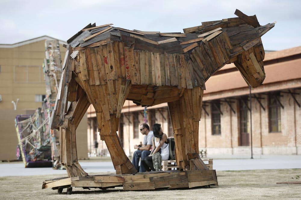 A wooden sculpture by Brazilian artist Joao Jitujeusi sands on display in a plaza that is part of the ArtRua street art exhibition in Rio de Janeiro, Brazil.