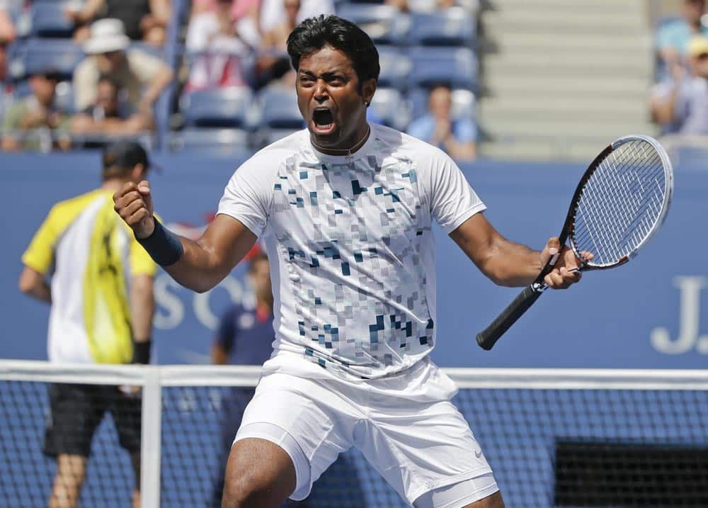 Leander Paes, turns and reacts to his partner Radek Stepanek, of the Czech Republic, during the men`s doubles quarterfinals against Mike and Bob Bryan at the 2013 US Open tennis tournament.