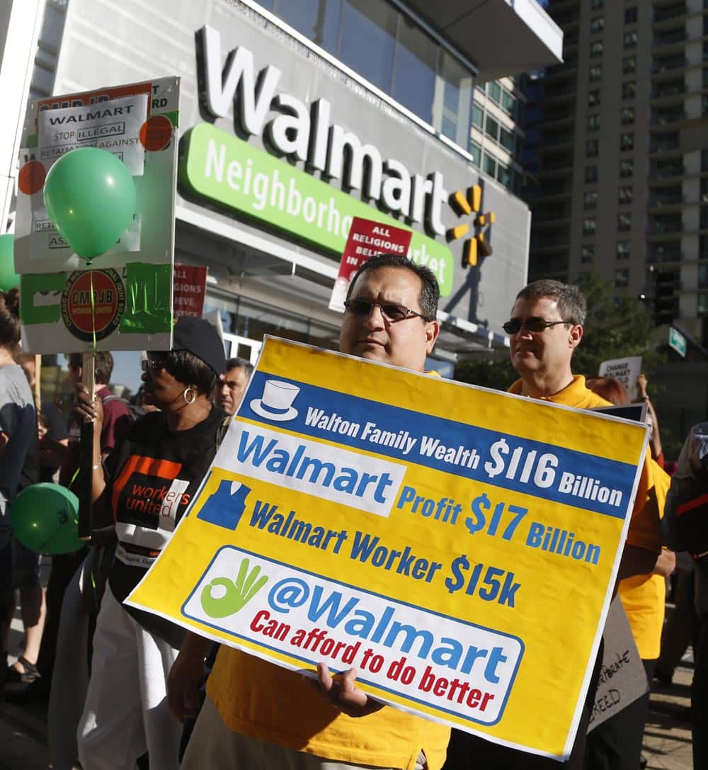 Protesters gather outside a Walmart Neighborhood Store for a peaceful demonstration, in Chicago. A handful of protesters participated in an act of civil disobedience by standing in the street and then taken into custody and given misdemeanor tickets.