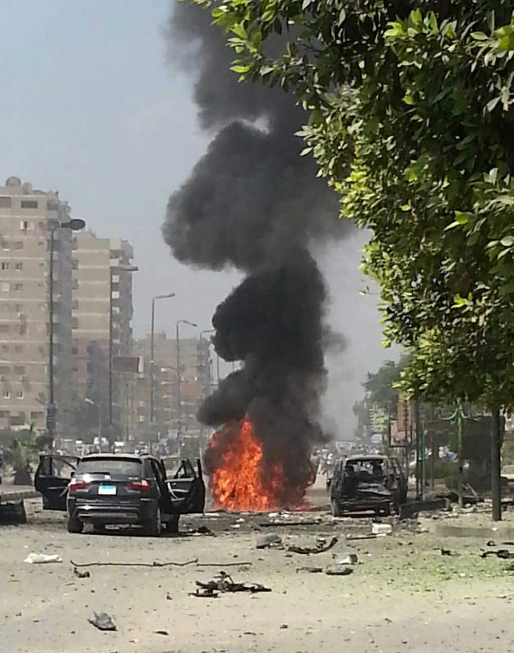 Black smoke billows from a burning car moments after a bomb attack targeted the convoy of Egypt`s Interior Minister Mohammed Ibrahim, in Nasr City, Egypt.