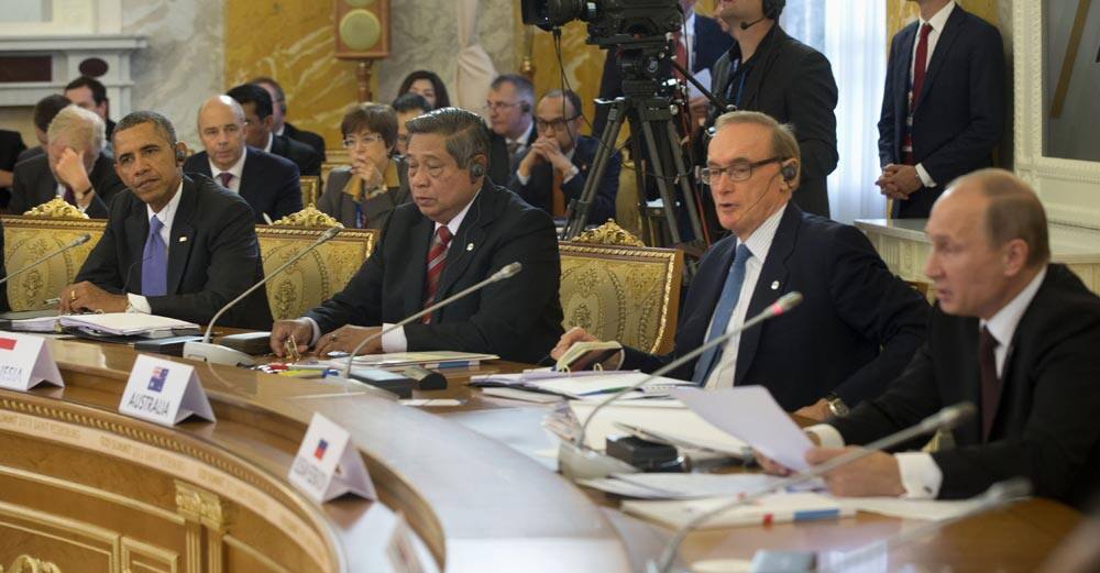 President Barack Obama listens at let as Russian President Vladimir Putin, far right, speaks during the start of the G-20 Working Session at the Konstantin Palace in St. Petersburg, Russia.