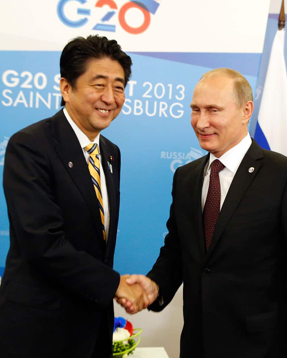 Russia`s President Vladimir Putin, right, shakes hands with Japan`s Prime Minister Shinzo Abe during a meeting at a G-20 summit in St. Petersburg, Russia.