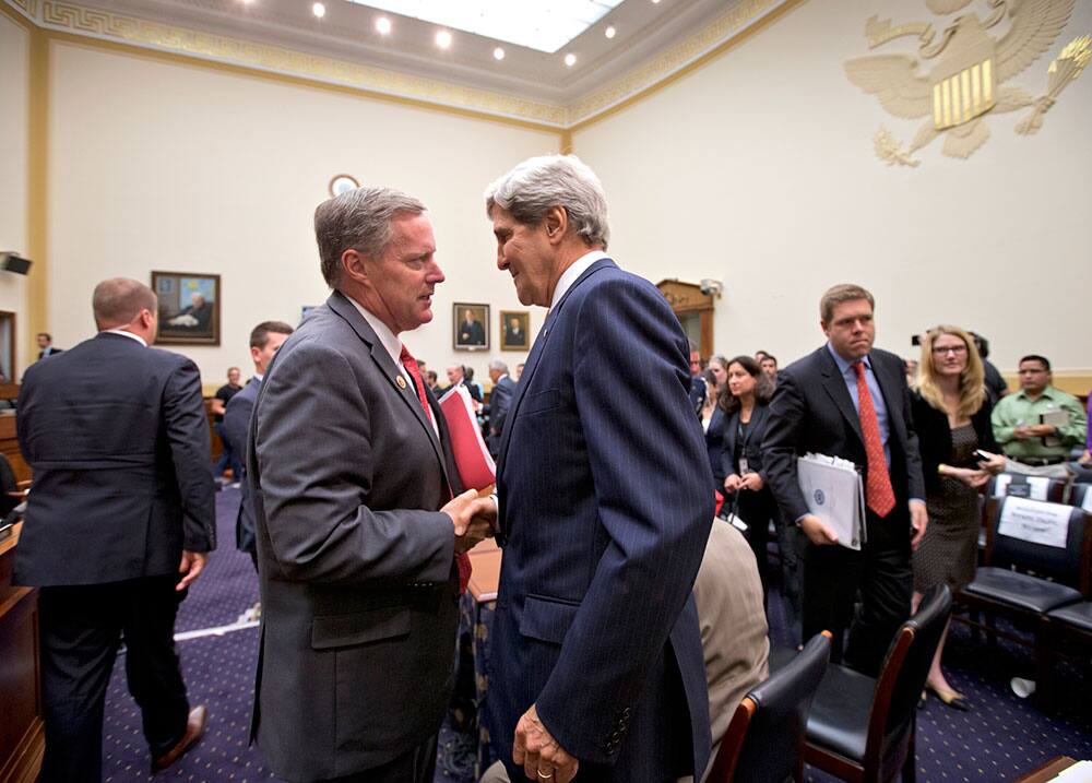 Secretary of State John Kerry speaks with Rep. Mark Meadows, R-N.C. at the close of a nearly five hours of questions at a House Foreign Affairs Committee hearing on President Barack Obama`s request for congressional authorization for military intervention in Syria, a response to last month`s alleged sarin gas attack in the Syrian civil war, on Capitol Hill in Washington.