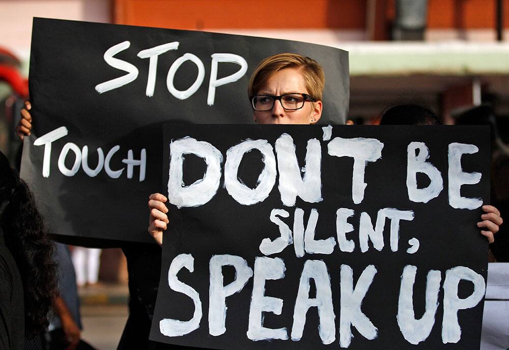 A woman holds a placard as she joins others during a protest against the alleged sexual harassment of women in public buses in Bangalore.