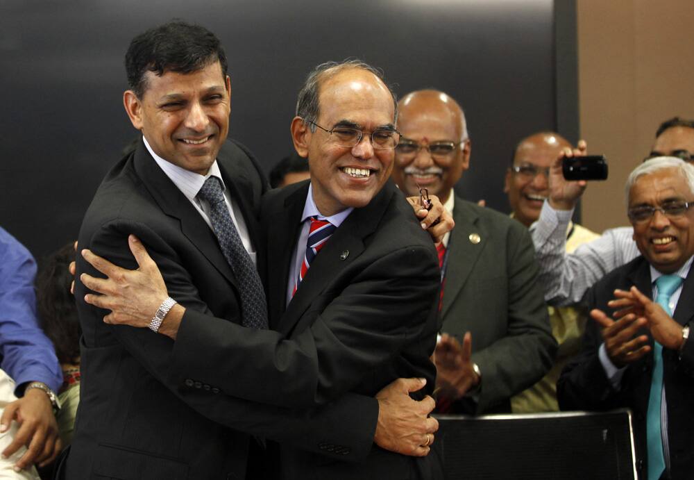 Reserve Bank of India’s (RBI) newly appointed governor Raghuram Rajan, left is greeted by outgoing governor Duvvuri Subbarao after taking charge, at the RBI headquarters in Mumbai.