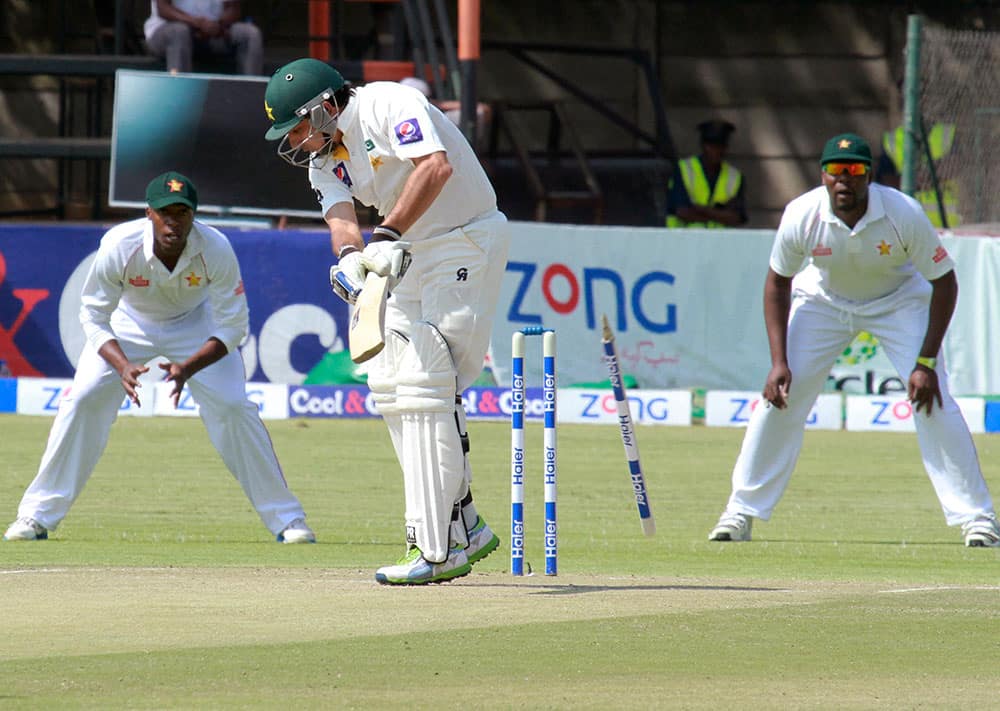 Pakistani batsman Saeed Ajmal, second from left, is bowled out for 49 runs during a first test match against Zimbabwe at Harare Sports Club.