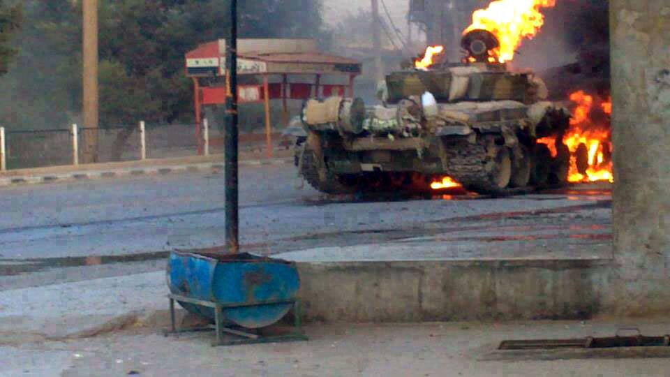 Revolution against Bashar Assad which has been authenticated based on its contents and other AP reporting, a Syrian military tank caught on fire during clashes with Free Syrian army fighters in Joubar a suburb of Damascus, Syria.