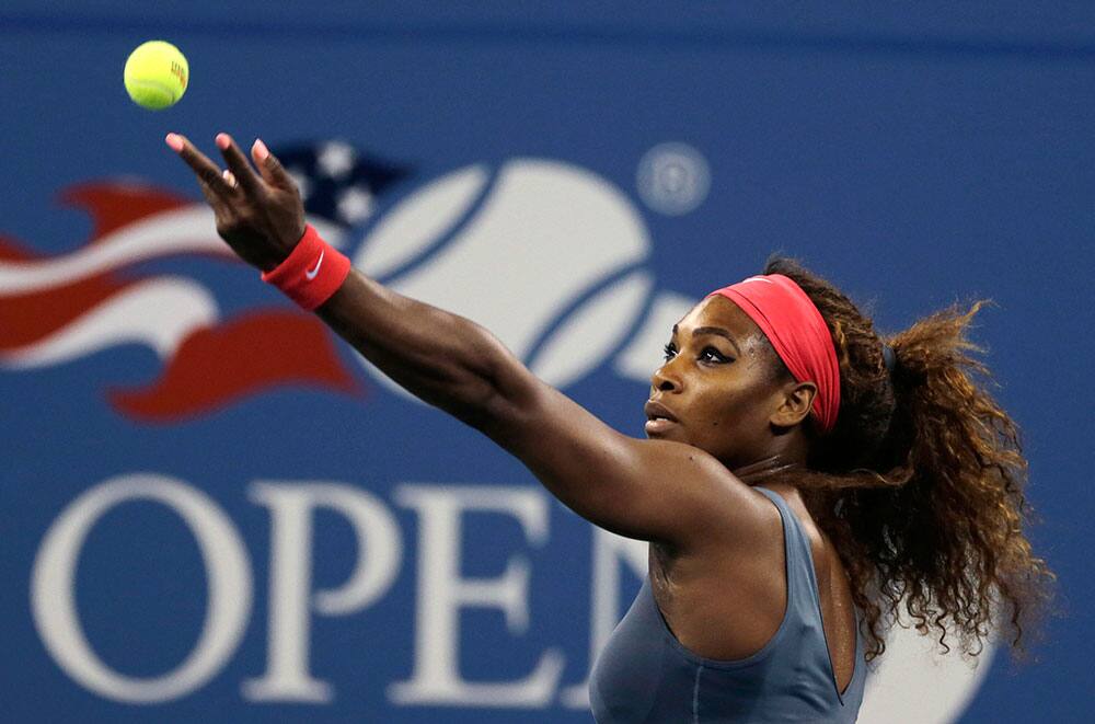 Serena Williams, of the United States, tosses the ball on a serve to Carla Suarez Navarro, of Spain, during a quarterfinal of the US Open tennis tournament.