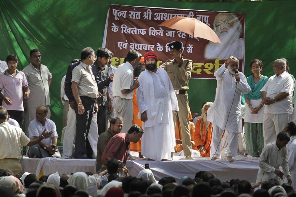 Controversial spiritual guru Asaram Bapu`s son Narayan Sai, center in red cap, attends a rally called in support of his father in New Delhi.