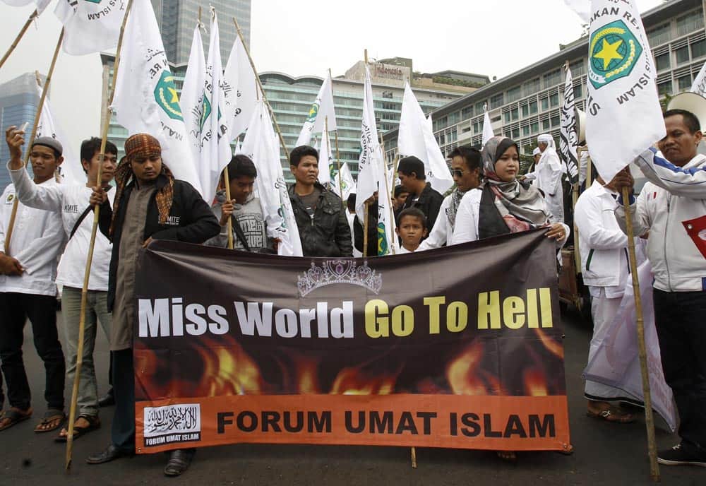 Muslim men display a banner during a protest calling for the cancellation of Miss World pageant in Jakarta. Hardliners in the world`s most populous Muslim country staged the protest Tuesday, demanding the government to ban the pageant that is scheduled to be held later this month saying that it goes against moral values.