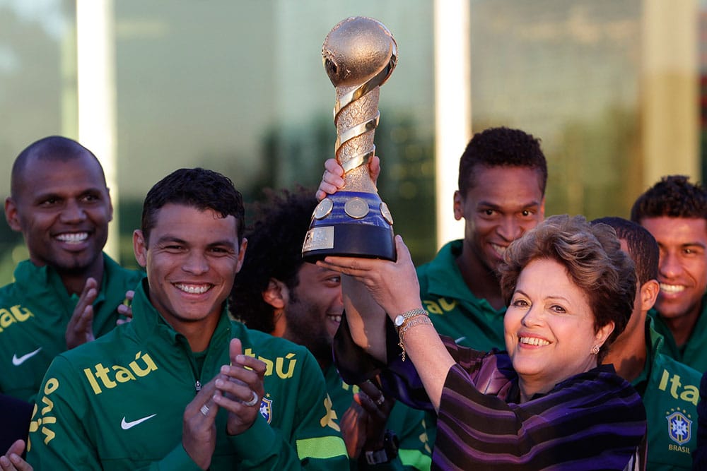 Brazil`s President Dilma Rousseff holds up the Confederations Cup trophy during her meeting with players of Brazil`s national soccer team at Alvorada palace in Brasilia, Brazil.