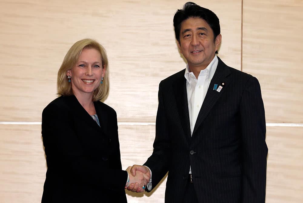 Japanese Prime Minister Shinzo Abe, right, shakes hands with US Sen. Kirsten Gillibrand, D-NY., chairwoman of the Armed Services personnel subcommittee during their meeting at the prime minister`s official residence in Tokyo.