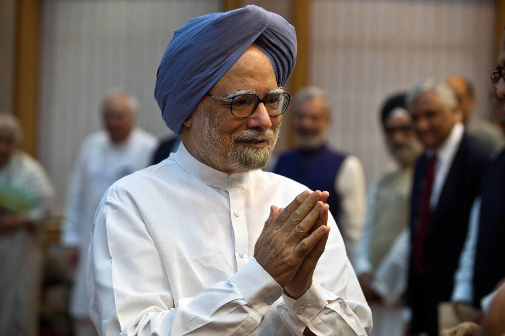 Prime Minister Manmohan Singh gestures as he arrives for a ceremony to launch of