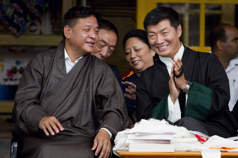 Prime Minister of the Tibetan government-in-exile Lobsang Sangay, right, listens to the Speaker of the Tibetan Parliament Penpa Tsering as they watch cultural performances during the Tibetan Democracy Day celebrations at the Tsuglakhang temple in Dharmsala.