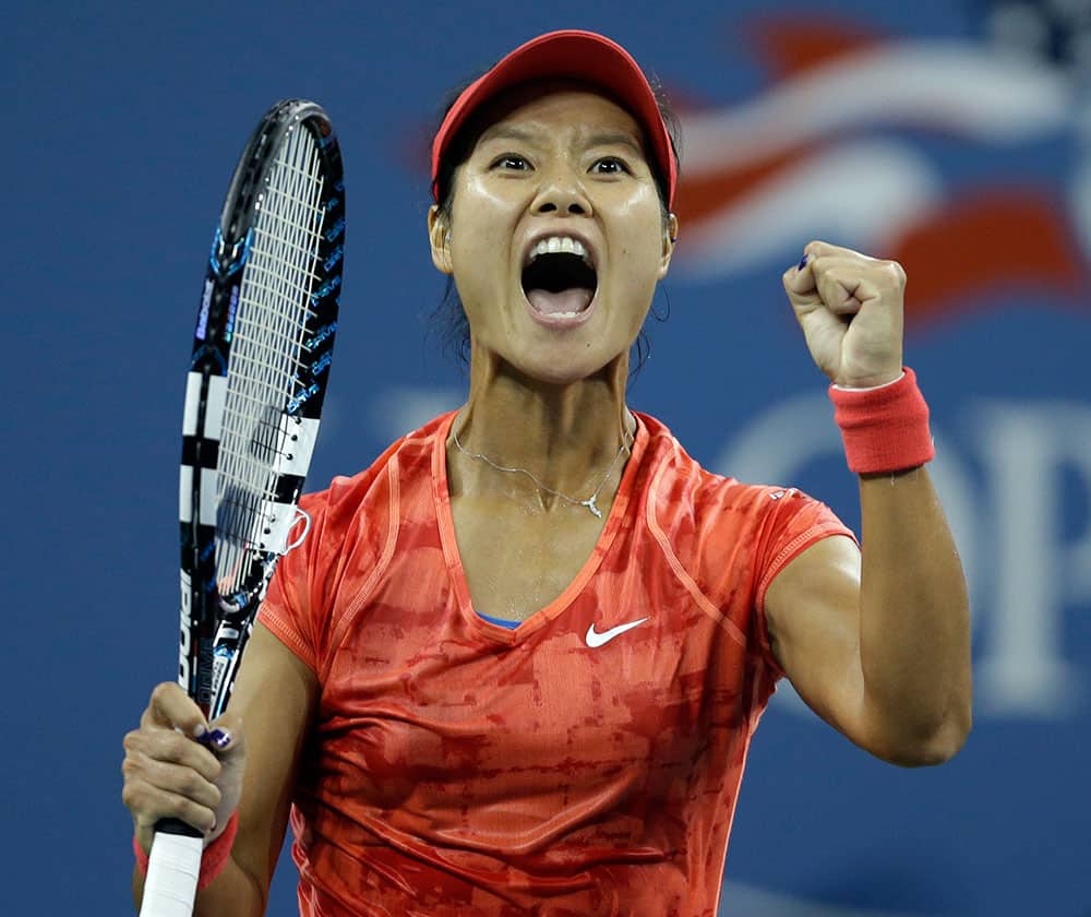 Li Na, of China, reacts after defeating Jelena Jankovic, of Serbia, in a fourth round match at the US Open tennis tournament.