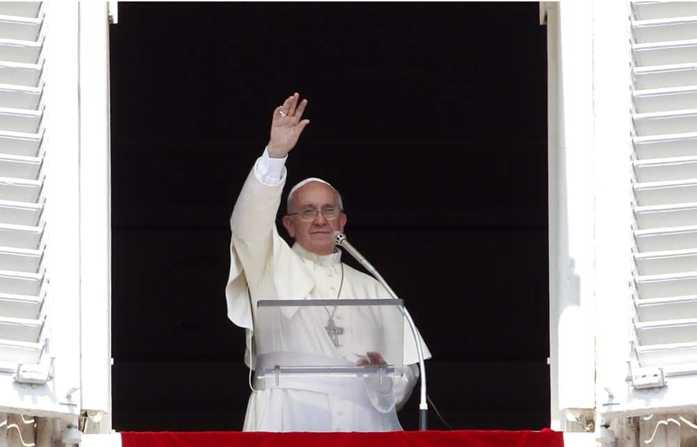 Pope Francis waves to faithful after reciting the Angelus prayer from his studio window overlooking St.Peter`s Square at the Vatican.