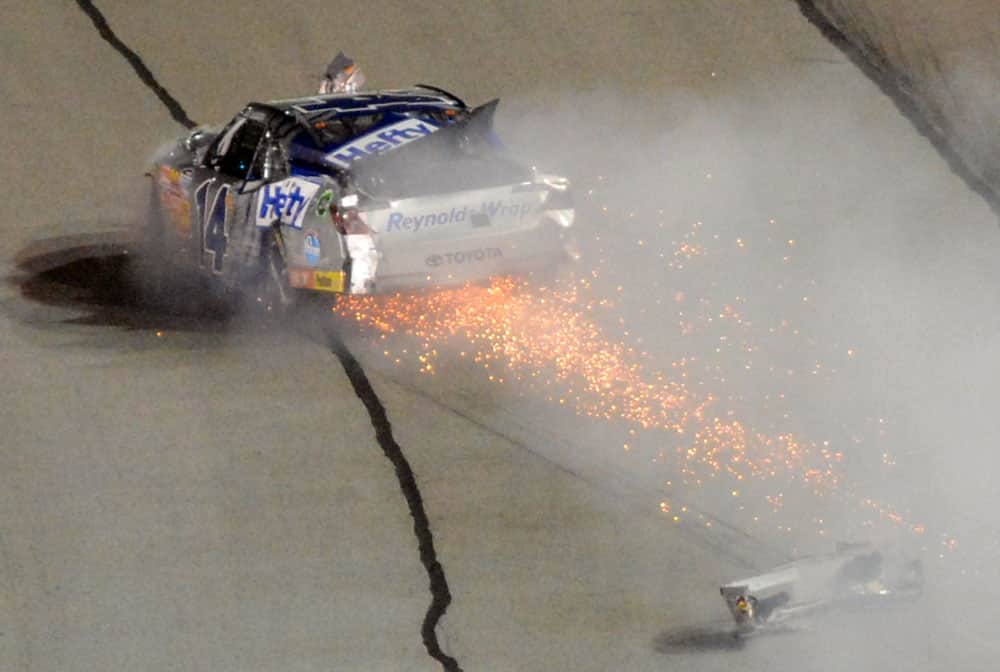 Driver Jeff Green (14) blows an engine and loses a bumper late in the Nationwide Series auto race at Atlanta Motor Speedway.