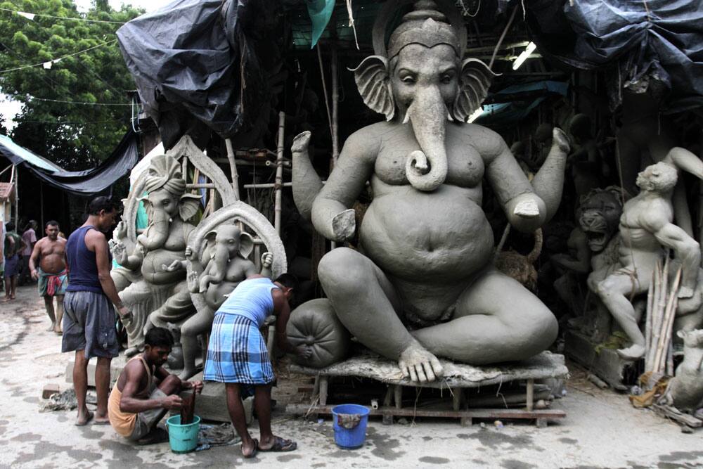 Artisans make clay idols of the elephant-headed Hindu God Ganesha ahead of the Ganesh Chaturthi festival in Kolkata.