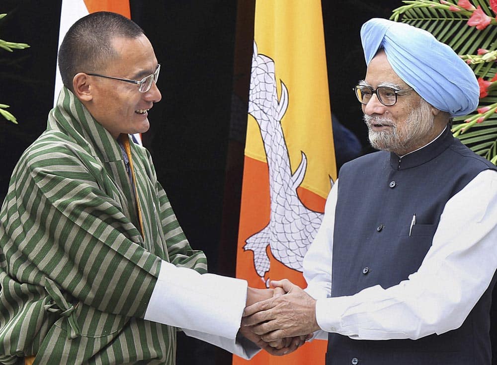 Prime Minister Manmohan Singh, right, shakes hands with his Bhutanese counterpart Lyonchhen Tshering Tobgay during a meeting in New Delhi.
