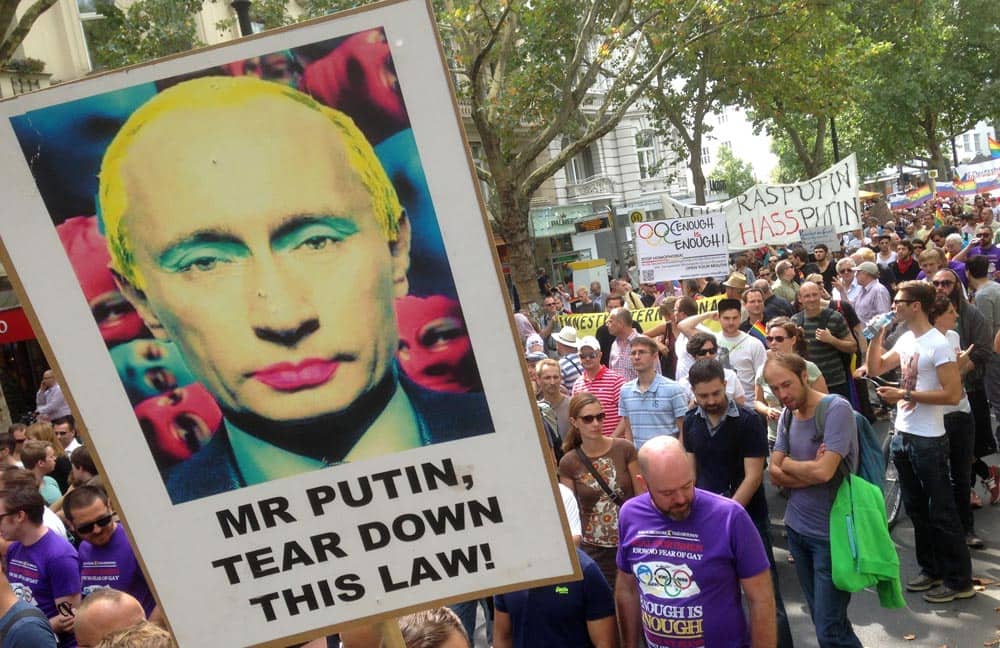 A demonstrator holds a poster with the portrait of Russian President Vladimir Putin during a protest march in Berlin, Germany.
