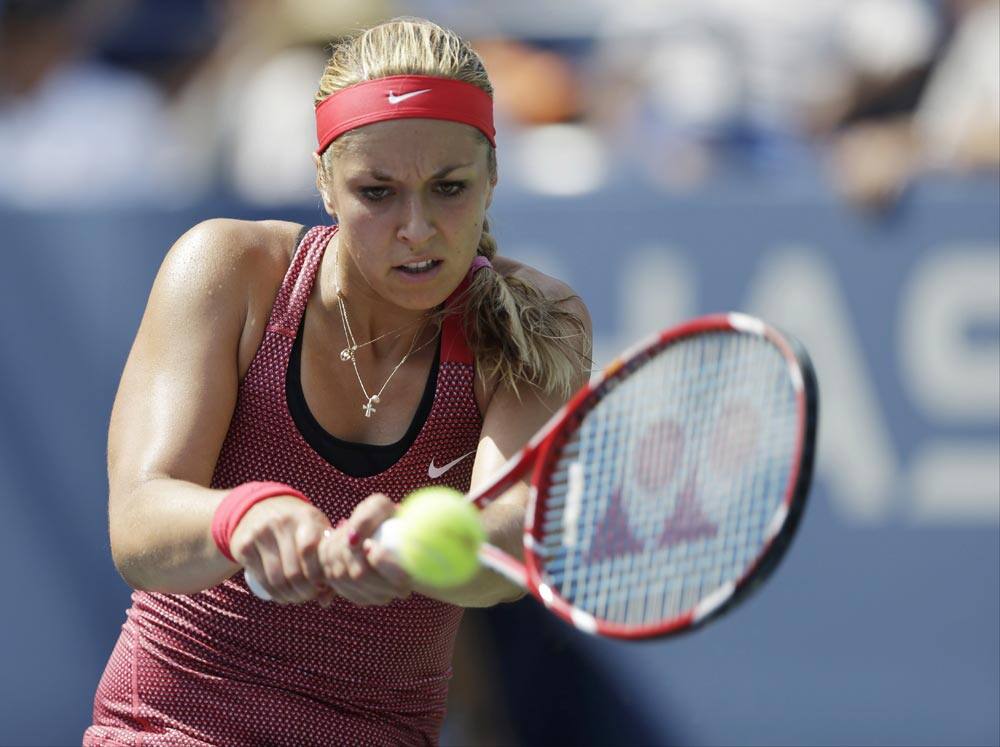 Sabine Lisicki of Germany returns a shot against Ekaterina Makarova of Russia during the second round of the 2013 US Open tennis tournament.