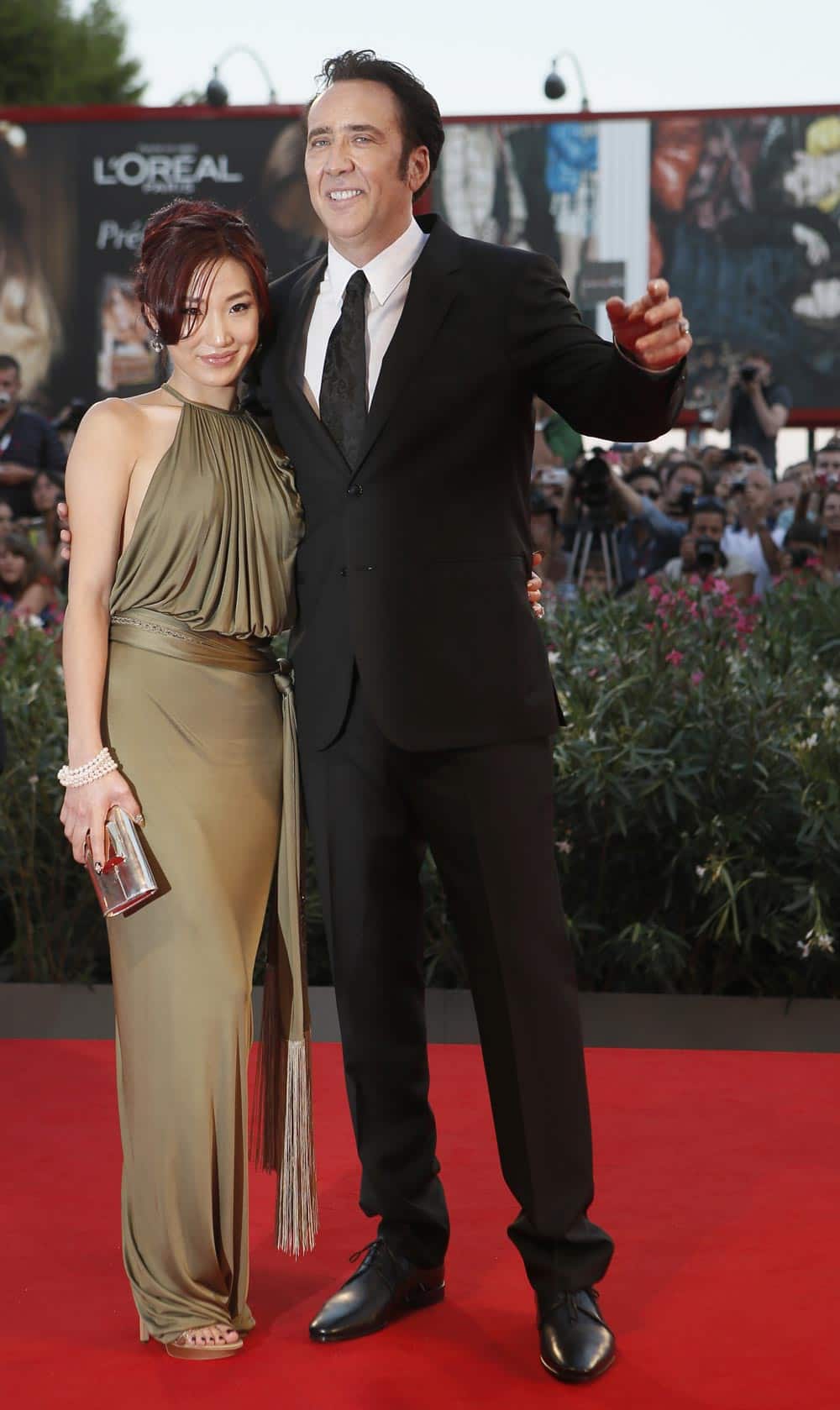 Actor Nicolas Cage, right, and his wife Alice Kim arrive for the screening of the film Joe at the 70th edition of the Venice Film Festival.