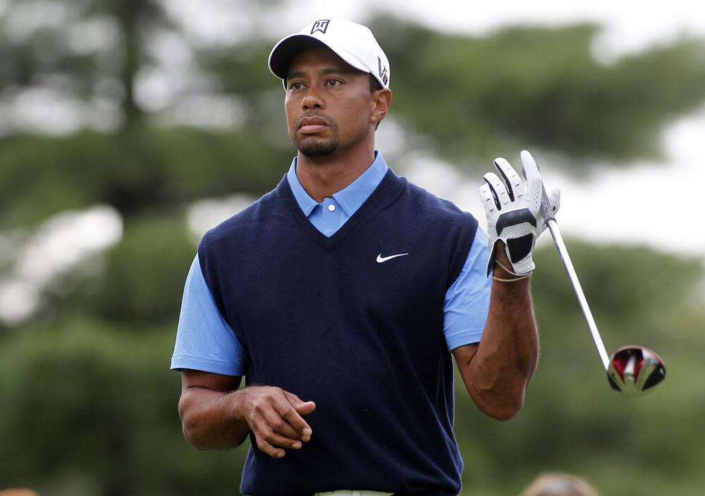 Tiger Woods waits to tee off on the 10th tee during the first round of the Deutsche Bank Championship golf tournament in Norton, Mass.