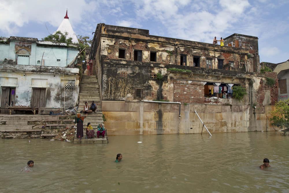 People take bath in the flooded River Ganges in Allahabad. Monsoon season, which runs from June to September, brings rain that is vital to agriculture but also causes floods and landslides.