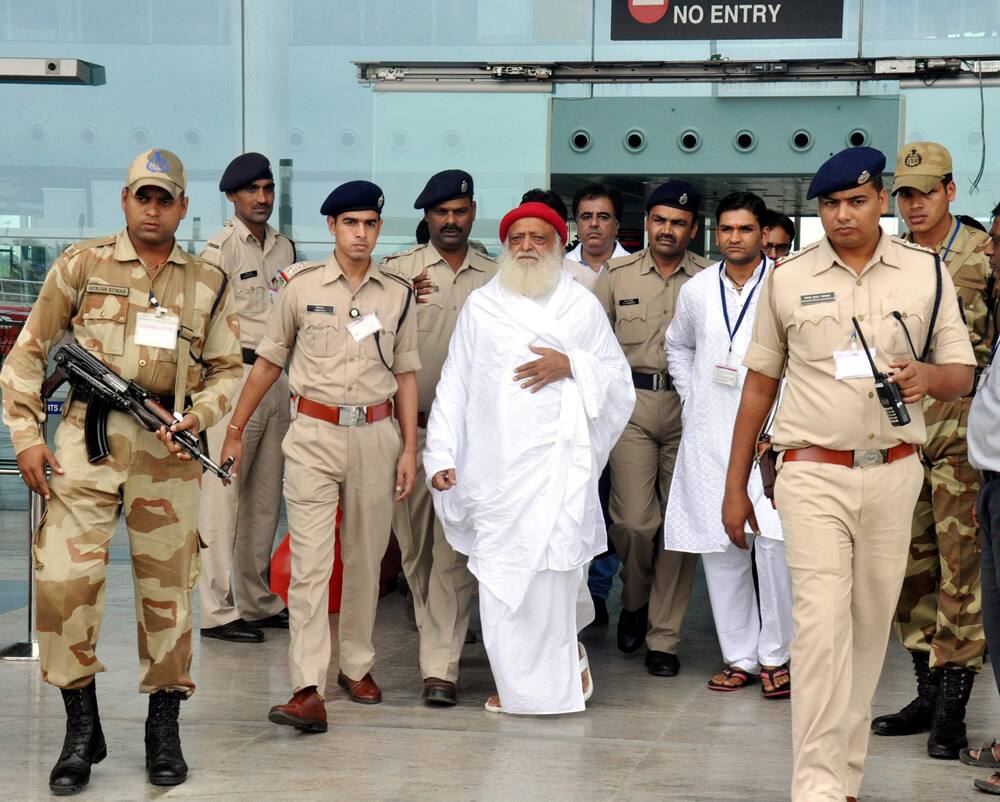 Asaram Bapu arrives at the airport in Bhopal. Bapu, who is accused of sexually assaulting a minor, will face arrest if he fails to appear before the Jodhpur Police on Friday, a top police officer has said.